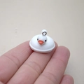 Miniature resin white duck charm with orange beak held by fingers for scale reference - W20 / White Duck