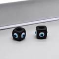 Macro shot of two square black resin evil eye beads with large holes for DIY jewelry - N315 / Black Eye