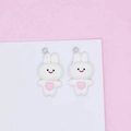 Close-up of white rabbit charms with pink hearts and metal loops for DIY jewelry making - White Rabbit Pink Heart