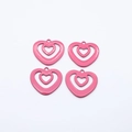 Close-up of four bright pink hollow heart-shaped alloy pendants for jewelry DIY - Rose Red