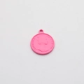 Macro detail of round pink alloy pendant featuring Queen Elizabeth II relief for DIY jewelry - Rose Red Portrait