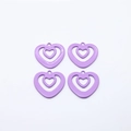 Close-up of four purple alloy heart-shaped hollow charms for DIY earring and necklace making - Purple