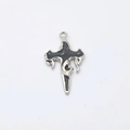 Macro view of gothic cross pendant with silver alloy finish and black enamel flame details - Silver-Gray Cross