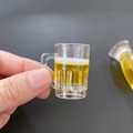 Miniature resin beer mug pendant featuring white foam and realistic yellow liquid design - Handle Beer Mug