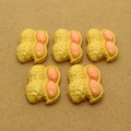Five pieces of creative resin peanut charms with pink nuts on a brown background - Peanut