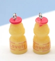 Macro shot of 3D resin drink bottle pendants with red caps and Lovely logo for DIY - Lovely Style / Rose Red