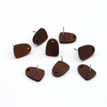 Macro view of eight trapezoidal dark wood stud earrings with natural grain on white background - Nail Shaped Wood