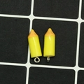 Detailed view of yellow resin pencil pendants with silver loops for DIY craft projects - Yellow Crayon