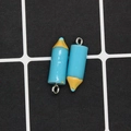 Macro shot of two creative blue and yellow pencil charms for DIY jewelry making - Blue Crayon