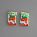 Close-up of miniature clover chips resin pendants with silver metallic rings for DIY - Style Clover Letter
