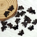 Detailed view of black butterfly charms with glossy finish for DIY jewelry crafts - Butterfly