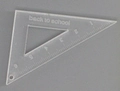 Close-up of a clear acrylic triangle ruler charm with 6cm scale and back to school text - Transparent Triangle Ruler