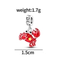 Macro detail of red crab charm in 925 silver with enamel and Gemini symbol ring - Cancer