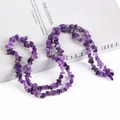 Natural amethyst chips stone necklace displayed on white book for an elegant jewelry look - Amethyst