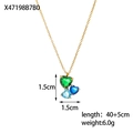 Macro view of gold pendant featuring three heart-shaped green and blue zircons - Triple Heart Zircon Blue Green Gold Style (XX47198B7B0)