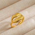 Macro detail of 18k gold plated lip shaped ring with textured vertical ridges on fabric box - 39-Gold Lips