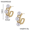 Detail view of U-shaped gold earrings with textured finish and three white pearls - Gold Vintage Carved Three Pearl Studs (YE42699D2G0)