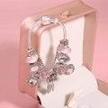 Detail of pink charm bracelet featuring dreamcatcher and heart charms on a jewelry box - 16cm / Pink Style (LPH23811/1710-1)