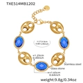 Macro detail of 18k gold plated stainless steel bracelet with blue glass stone and pig nose links - Blue Glass Stone Gold Bracelet