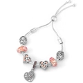 Macro detail of rose gold charm bracelet featuring floral beads and tree of life charms - Tree of Life Pink Glass Style (012)