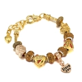 Detail of golden charm bracelet with heart pendant and Paris suitcase charm charms - Yellow