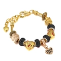 Detail of gold charm bracelet with I love you heart pendant and Paris bead accents - 16cm / Black