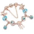 Rose gold charm bracelet with blue crystals and dreamcatcher pendant on white background - 16cm / Blue Dreamcatcher Style (Rose Gold Bracelet 1)