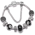 Detailed close-up of a silver snake chain bracelet with black enamel flower beads and zircons - Fashion Black White Flower Style (6)