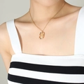 Elegant gold necklace with multi-colored zircon oval pendant featuring letter U detail - Letter U