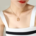 Elegant gold necklace with multi-color zircon letter W pendant on a female model - Letter W