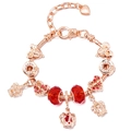 Detail of rose gold charm bracelet with red beads and crown pendants on a snake chain - Red Bead Crown Family Style (#2) / 16cm