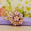 Elegant gold keychain with pink and white daisy flower ball and secure lobster clasp - White