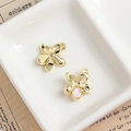Golden alloy flower pendant featuring a pink teardrop stone and intricate metal petals - Gold Flower Pendant with Pink Teardrop Stone (27#)