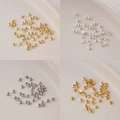 Macro detail of polished gold and silver triangular metal spacer beads for DIY jewelry - 3mm Straight Hole Flat Triangle (5g, approx 120 pcs) / 14K Gold