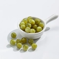 Translucent light green cat eye glass beads for DIY jewelry making in a white ceramic spoon - 12mm Gilded Grass Green
