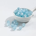 10mm light blue cat-eye resin beads in a white ceramic spoon for DIY jewelry making - 10mm Lake Blue Cat Eye