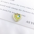 Golden heart pendant featuring green and white tulip enamel for DIY jewelry making - Green Heart Tulip Gold