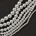 Close-up of white acrylic faux pearls in various sizes for DIY jewelry and accessories - 3mm / Pure White