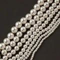 Macro detail of white acrylic faux pearls in various sizes for DIY jewelry making - 3mm / Off-white