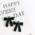DIY charm accessories featuring two glossy black alloy bow pendants on a card - Black