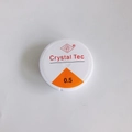 Close-up of 0.5mm clear elastic crystal bead cord on a white spool for DIY jewelry - 0.5mm