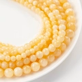 Natural yellow jade beads in various sizes for DIY jewelry making on white ceramic plate - 8# Cheese Milk Cap