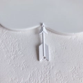 Macro view of a minimalist white arrow accessory with textured fletching for DIY jewelry - White Arrow Style
