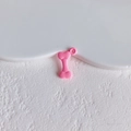 Detailed view of a shiny pink bone-shaped alloy pendant with hole for DIY jewelry design - Light Pink Bone Style