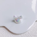 Detailed macro of iridescent acrylic bow charm for DIY jewelry and phone chain material - Aurora Rainbow