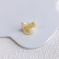 Close-up of iridescent pastel yellow bow bead for DIY jewelry and phone charms - Pearlescent Bright Yellow