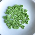 Close-up of light green heart-shaped hollow beads with butterfly patterns for DIY jewelry - Light Green