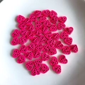 Close-up of rose red hollow heart beads for DIY jewelry and handmade accessories - Rose Red