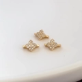 Macro shot of 18k gold plated four-petal flower connectors with micro-pave cubic zirconia - Gold (kp5881)