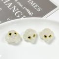 Macro view of sparkly resin dog beads with yellow eyes for DIY jewelry making - Off-white with Glitter (11#)